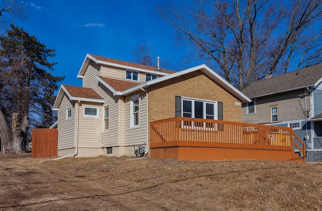 703 Maxwelton Dr, Des Moines, IA 50315 - back of house featuring a deck, brick siding, and a shingled roof