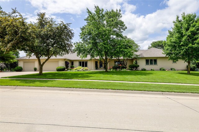 4416 Oakwood Ln, West Des Moines, IA 50265 - single story home with an attached garage, a front lawn, concrete driveway, and stucco siding