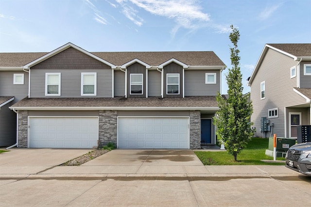 2817 NW Lois Ln, Ankeny, IA 50023 - multi unit property featuring stone siding, concrete driveway, roof with shingles, and a garage