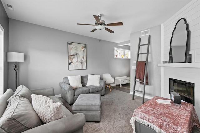 2817 NW Lois Ln, Ankeny, IA 50023 - living room featuring ceiling fan, carpet, and a large fireplace