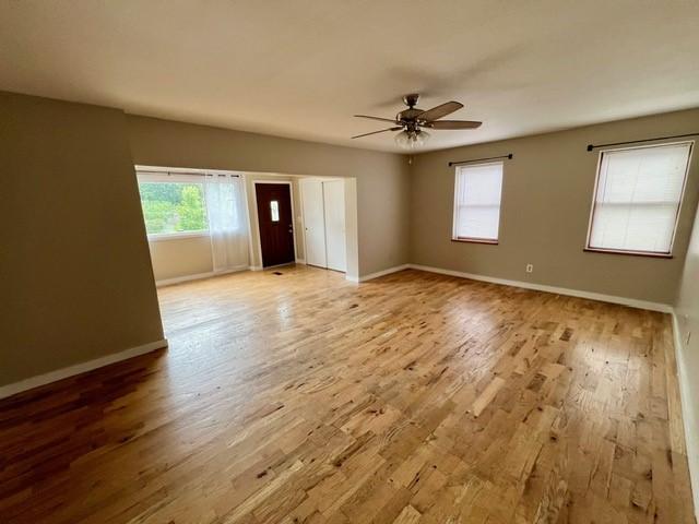 1506 Main St, Adel, IA 50003 - empty room featuring ceiling fan and wood finished floors