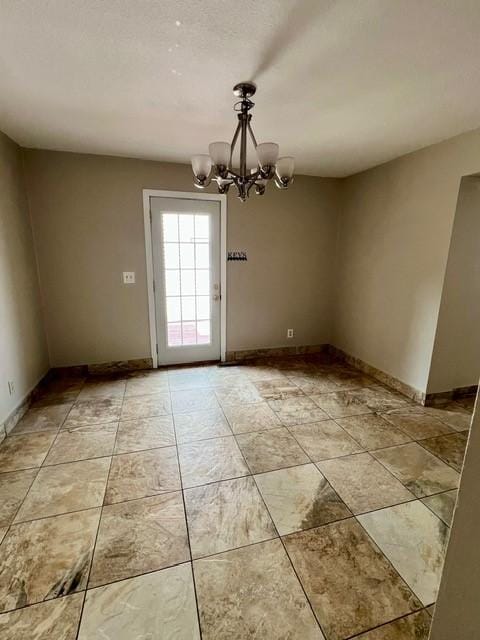 1506 Main St, Adel, IA 50003 - unfurnished dining area featuring a chandelier and baseboards