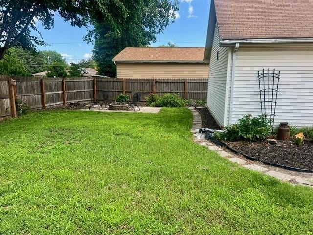 1506 Main St, Adel, IA 50003 - fenced backyard with an outdoor fire pit