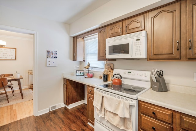 2508 46th St, Des Moines, IA 50310 - kitchen with white appliances, light countertops, dark wood-type flooring, and brown cabinets