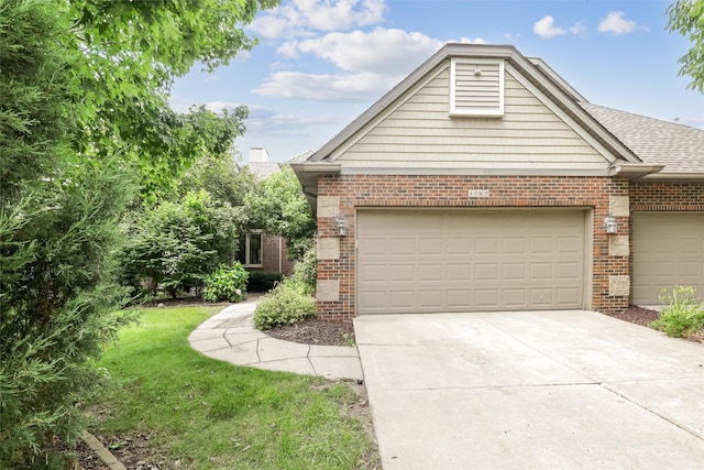 1069 Glen Oaks Dr, West Des Moines, IA 50266 - view of front of house featuring brick siding, concrete driveway, an attached garage, and roof with shingles
