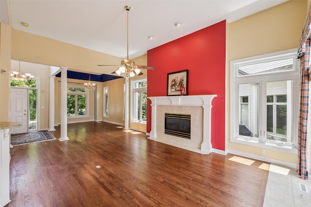 1069 Glen Oaks Dr, West Des Moines, IA 50266 - unfurnished living room with a chandelier, decorative columns, wood finished floors, a fireplace, and ceiling fan