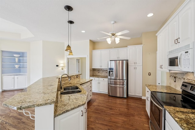 1069 Glen Oaks Dr, West Des Moines, IA 50266 - kitchen with stainless steel appliances, a ceiling fan, backsplash, dark wood-style floors, and white cabinetry