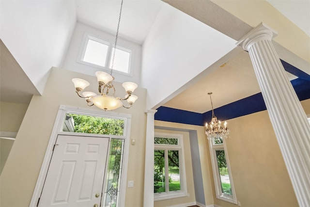 1069 Glen Oaks Dr, West Des Moines, IA 50266 - entryway featuring a chandelier, healthy amount of natural light, ornate columns, and a towering ceiling