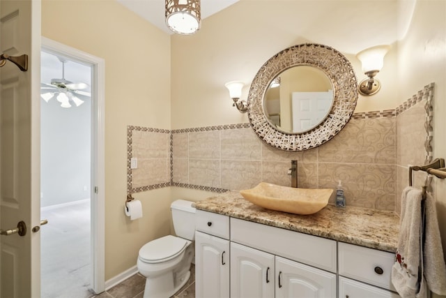 1069 Glen Oaks Dr, West Des Moines, IA 50266 - bathroom with tile walls, vanity, a ceiling fan, and tile patterned floors