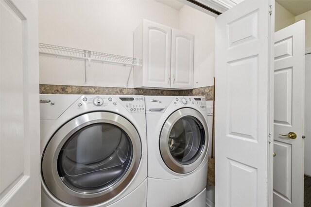 1069 Glen Oaks Dr, West Des Moines, IA 50266 - laundry room featuring separate washer and dryer and cabinet space