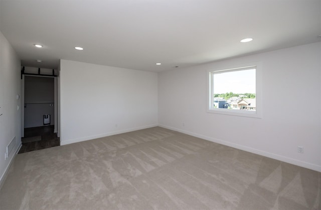 989 65th St, West Des Moines, IA 50266 - empty room with light carpet and recessed lighting