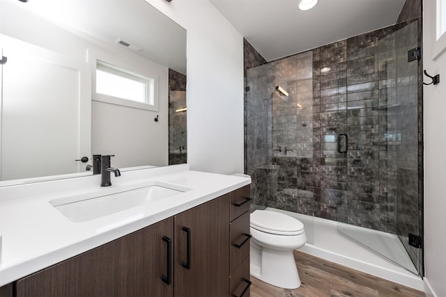 989 65th St, West Des Moines, IA 50266 - full bathroom featuring vanity, a shower stall, wood finished floors, and recessed lighting