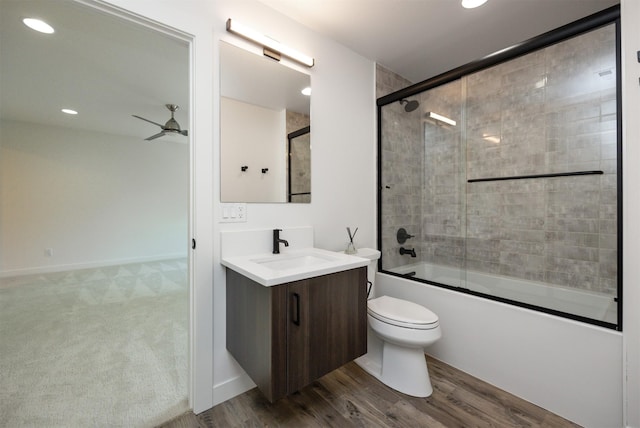 989 65th St, West Des Moines, IA 50266 - bathroom with vanity, combined bath / shower with glass door, a ceiling fan, recessed lighting, and wood finished floors