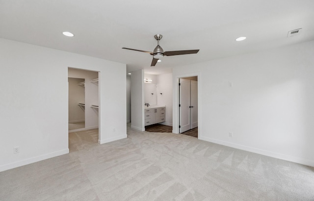 989 65th St, West Des Moines, IA 50266 - unfurnished bedroom featuring a spacious closet, carpet, recessed lighting, a closet, and ceiling fan