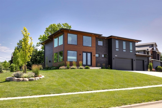 989 65th St, West Des Moines, IA 50266 - contemporary house with an attached garage, concrete driveway, and a front yard
