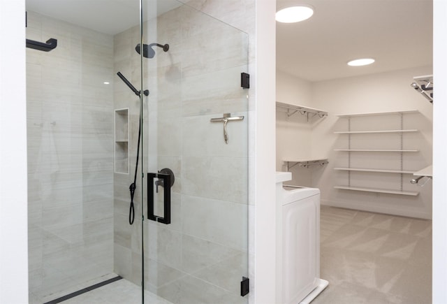 989 65th St, West Des Moines, IA 50266 - full bathroom featuring a shower stall, a walk in closet, and washer / clothes dryer