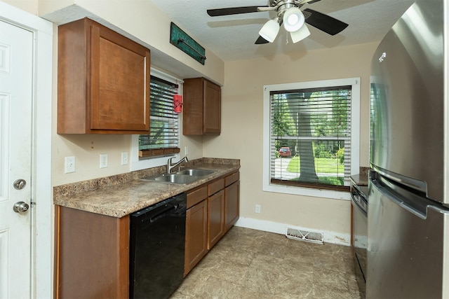 2421 Adams Ave, Des Moines, IA 50310 - kitchen featuring freestanding refrigerator, black dishwasher, a ceiling fan, and brown cabinetry