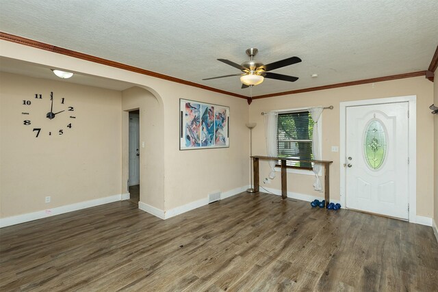 2421 Adams Ave, Des Moines, IA 50310 - foyer featuring a textured ceiling, arched walkways, a ceiling fan, wood finished floors, and crown molding