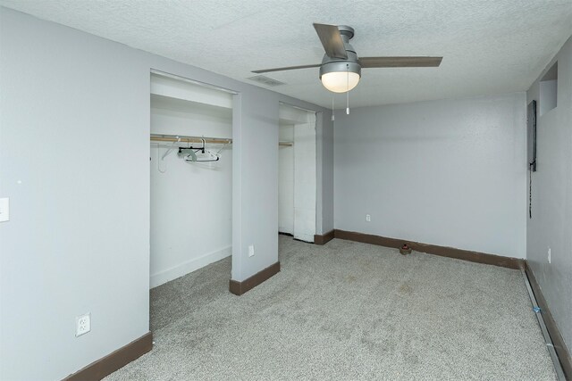 2421 Adams Ave, Des Moines, IA 50310 - unfurnished bedroom featuring carpet flooring, a textured ceiling, and a ceiling fan