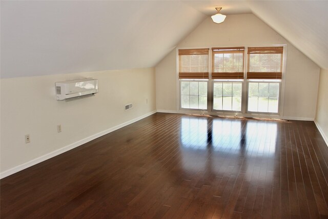 4015 Marigold Dr, Ames, IA 50014 - additional living space with lofted ceiling, dark wood-type flooring, and a wall unit AC