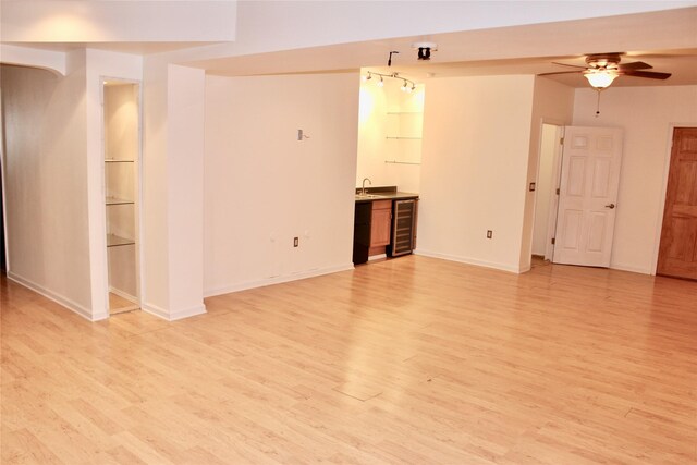 4015 Marigold Dr, Ames, IA 50014 - unfurnished living room with light wood-style floors, a ceiling fan, beverage cooler, and wet bar