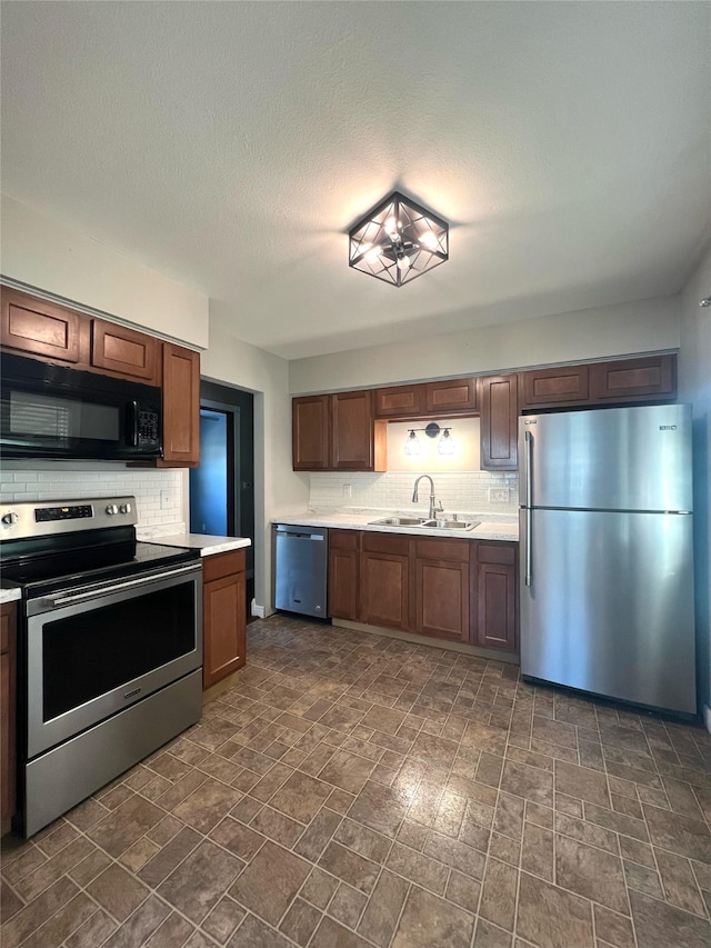 2612 Grandview Ave, Des Moines, IA 50317 - kitchen with stainless steel appliances, decorative backsplash, and light countertops