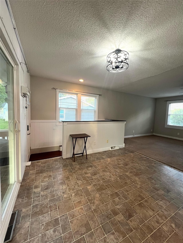 2612 Grandview Ave, Des Moines, IA 50317 - unfurnished room with a textured ceiling and wainscoting
