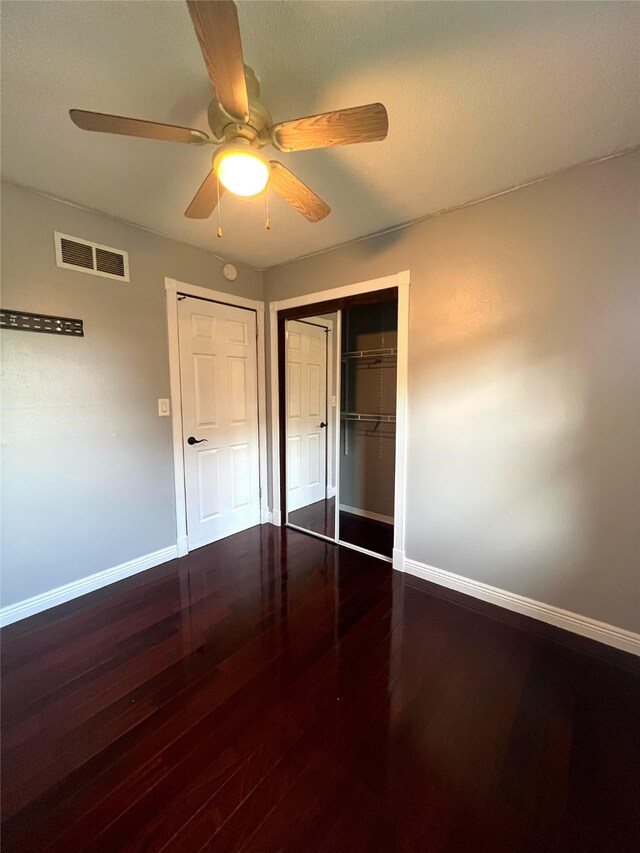 2612 Grandview Ave, Des Moines, IA 50317 - unfurnished bedroom featuring wood finished floors, a closet, and ceiling fan