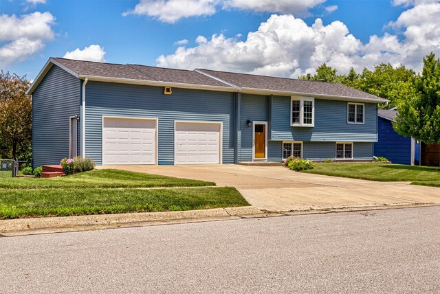 503 E 5th St, Huxley, IA 50124 - raised ranch with an attached garage, driveway, and a front lawn