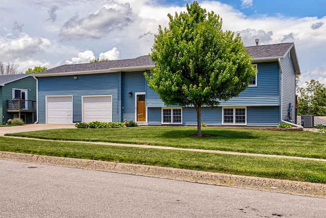 503 E 5th St, Huxley, IA 50124 - view of front of house featuring a garage, driveway, a front yard, and a shingled roof