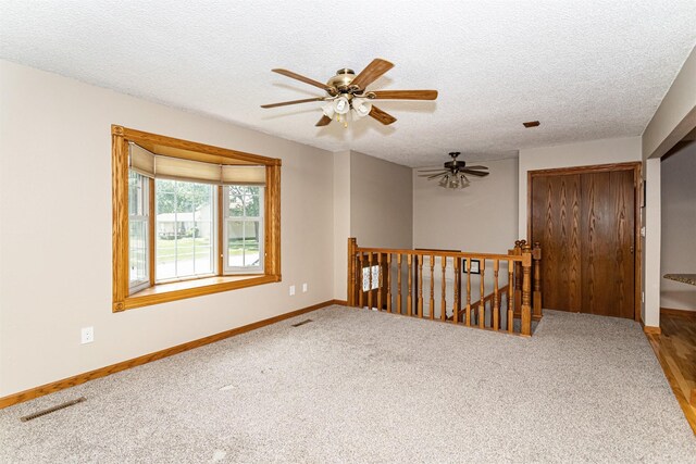 503 E 5th St, Huxley, IA 50124 - empty room with ceiling fan, a textured ceiling, and carpet flooring
