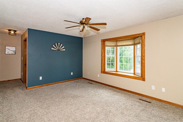 503 E 5th St, Huxley, IA 50124 - unfurnished room featuring a ceiling fan, carpet, and a textured ceiling