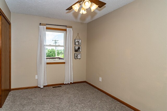 503 E 5th St, Huxley, IA 50124 - empty room with ceiling fan, carpet, and a textured ceiling