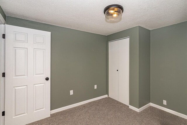 503 E 5th St, Huxley, IA 50124 - unfurnished bedroom featuring carpet flooring, a textured ceiling, and a closet