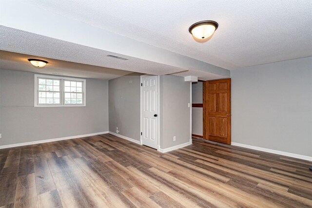 503 E 5th St, Huxley, IA 50124 - basement with wood finished floors and a textured ceiling