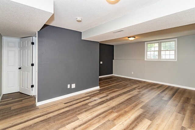 503 E 5th St, Huxley, IA 50124 - basement featuring wood finished floors and a textured ceiling