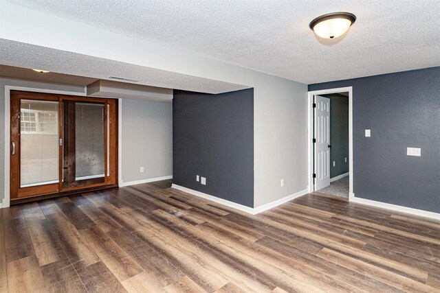 503 E 5th St, Huxley, IA 50124 - spare room featuring a textured ceiling and wood finished floors