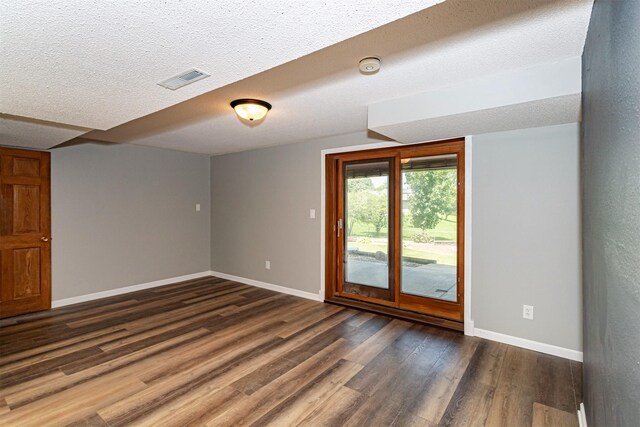 503 E 5th St, Huxley, IA 50124 - spare room with dark wood finished floors, a textured ceiling, and a smoke detector