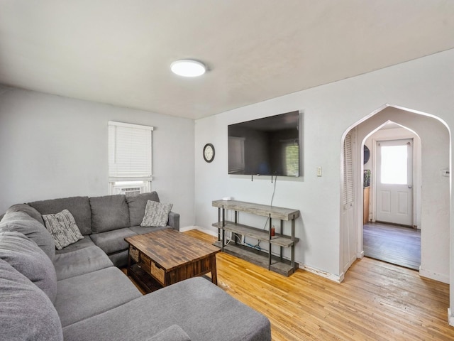 3504 27th St, Des Moines, IA 50310 - living room featuring arched walkways and light wood-style floors