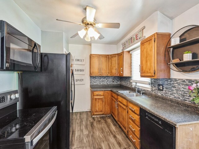 3504 27th St, Des Moines, IA 50310 - kitchen with black appliances, a ceiling fan, decorative backsplash, wood finished floors, and brown cabinets