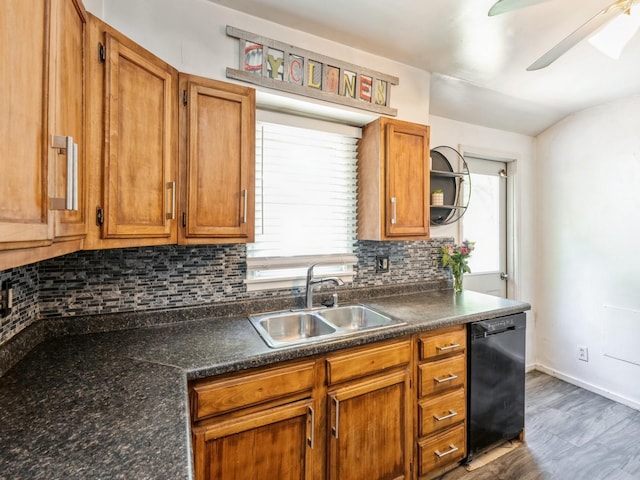 3504 27th St, Des Moines, IA 50310 - kitchen with dishwasher, decorative backsplash, dark countertops, and a ceiling fan