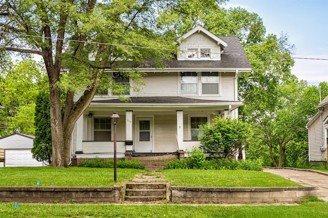 317 N Russell Ave, Ames, IA 50010 - traditional style home with a porch, an outdoor structure, roof with shingles, and a front lawn