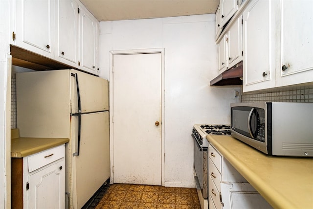 317 N Russell Ave, Ames, IA 50010 - kitchen featuring stainless steel microwave, freestanding refrigerator, gas range, under cabinet range hood, and white cabinetry