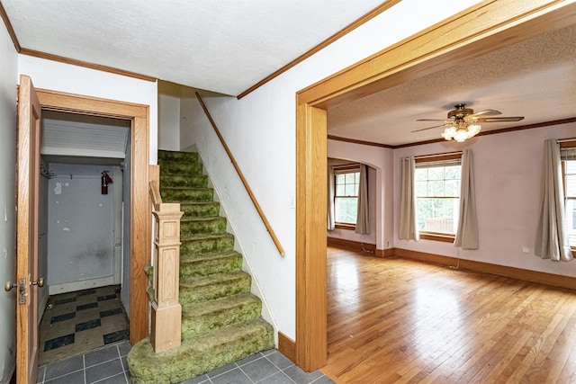 317 N Russell Ave, Ames, IA 50010 - stairs with crown molding, a textured ceiling, wood finished floors, ceiling fan, and arched walkways