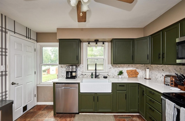 3925 55th St, Des Moines, IA 50310 - kitchen featuring green cabinets, stainless steel appliances, tasteful backsplash, and plenty of natural light