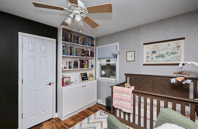 3925 55th St, Des Moines, IA 50310 - bedroom with dark wood-type flooring, a ceiling fan, and wallpapered walls