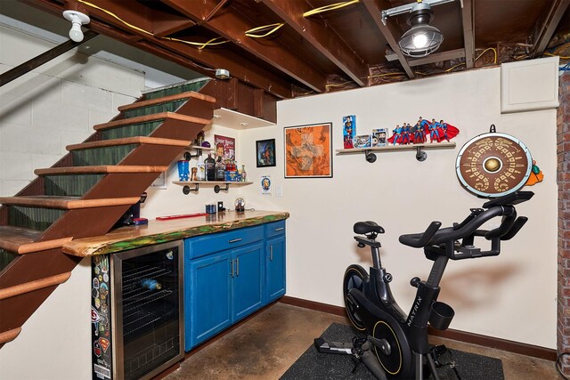 3925 55th St, Des Moines, IA 50310 - indoor dry bar with beverage cooler and concrete floors