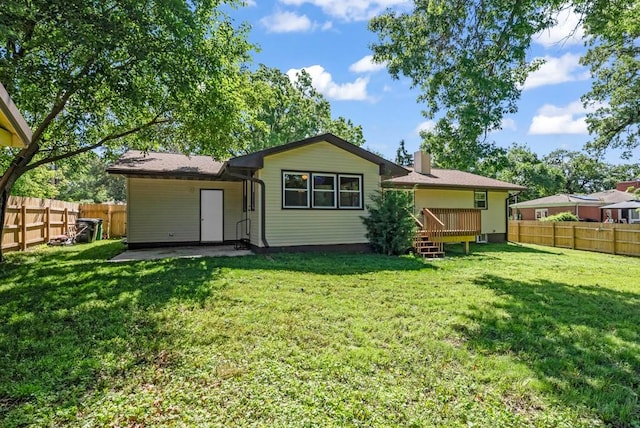 1516 73rd St, Windsor Heights, IA 50324 - rear view of property with a fenced backyard, a chimney, and a deck