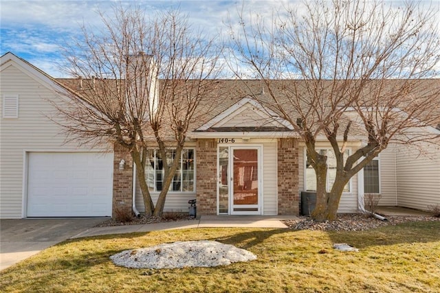 140 NW Georgetown Blvd Unit 6, Ankeny, IA 50023 - view of front of property with brick siding, concrete driveway, a front yard, and an attached garage