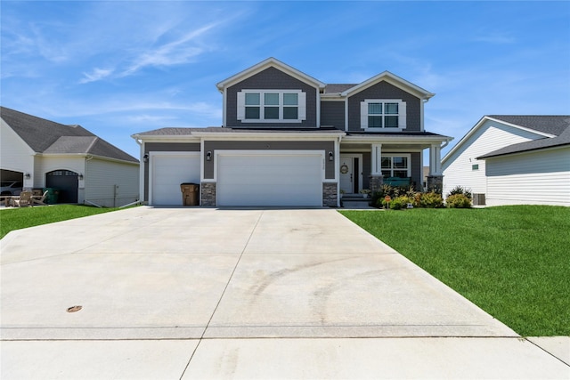 2920 Oak St, Norwalk, IA 50211 - craftsman inspired home with a front lawn, covered porch, concrete driveway, stone siding, and an attached garage